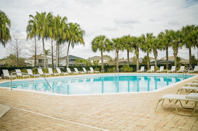 pool with a patio and fence