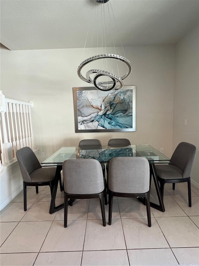 dining room featuring light tile patterned floors and baseboards