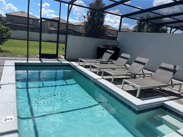 view of pool featuring a fenced in pool, a patio area, and glass enclosure