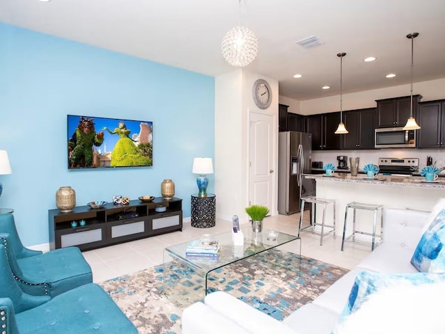 living area featuring recessed lighting, visible vents, and light tile patterned floors