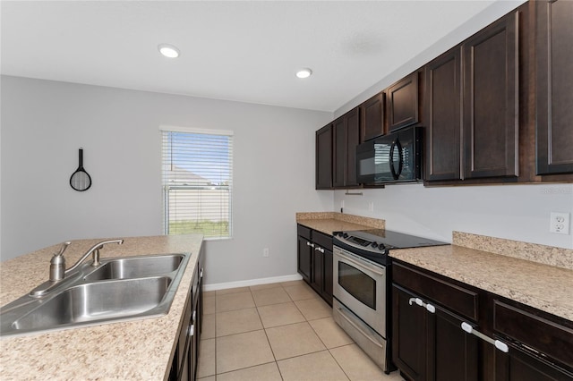 kitchen with black microwave, dark brown cabinetry, a sink, electric stove, and light countertops