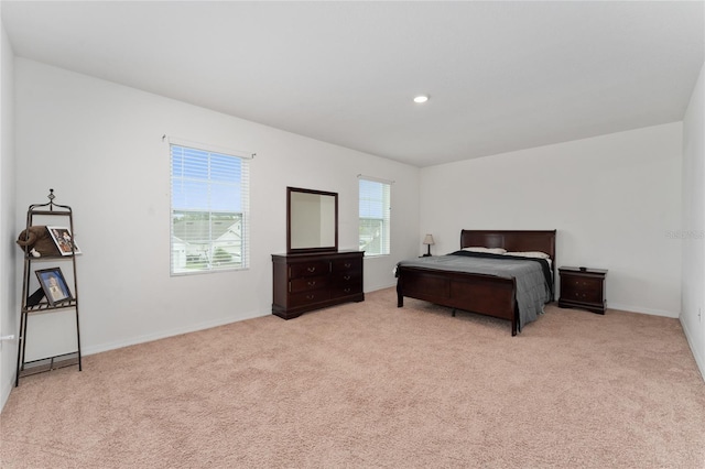 bedroom with recessed lighting, light carpet, and baseboards