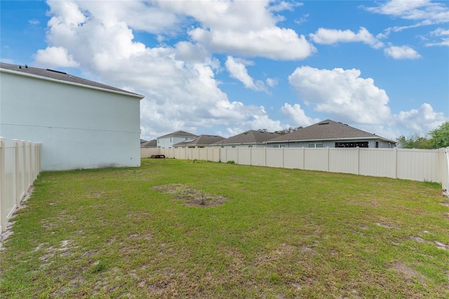 view of yard with a fenced backyard