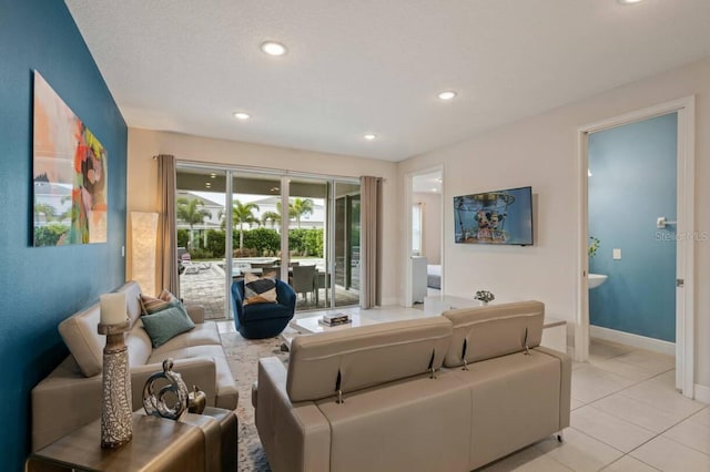 living room with recessed lighting, baseboards, and light tile patterned floors