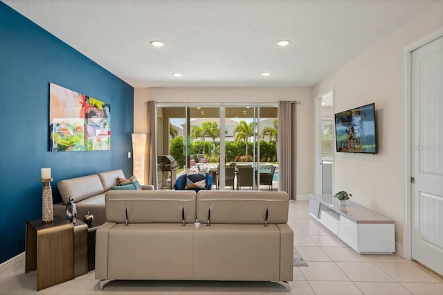 living room with light tile patterned floors, baseboards, and recessed lighting