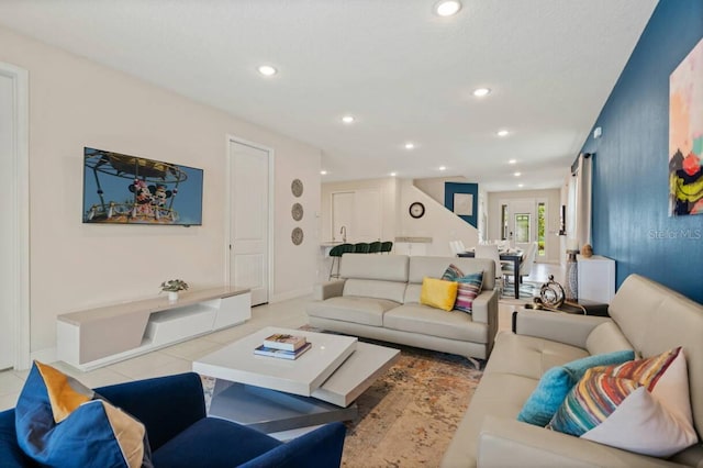 living area featuring baseboards, light tile patterned flooring, and recessed lighting