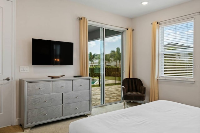 bedroom featuring access to exterior, recessed lighting, multiple windows, and light carpet