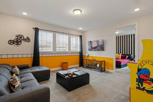 carpeted living area featuring baseboards and recessed lighting