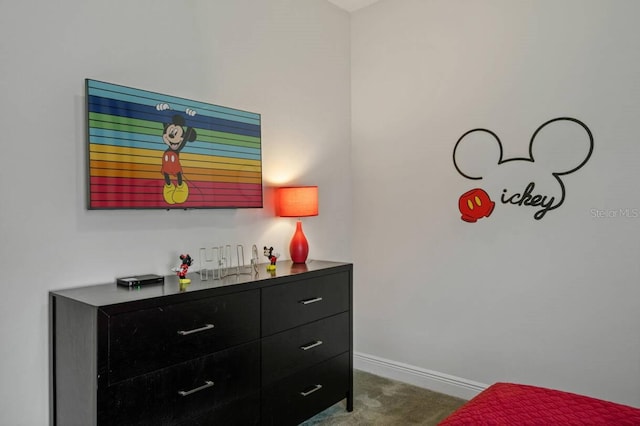 bedroom with baseboards and dark colored carpet