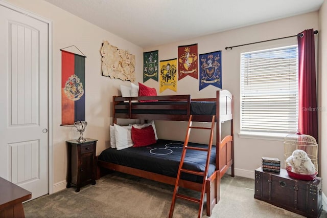 bedroom featuring carpet floors, multiple windows, and baseboards