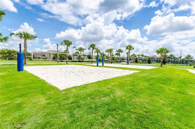 view of property's community featuring volleyball court and a yard