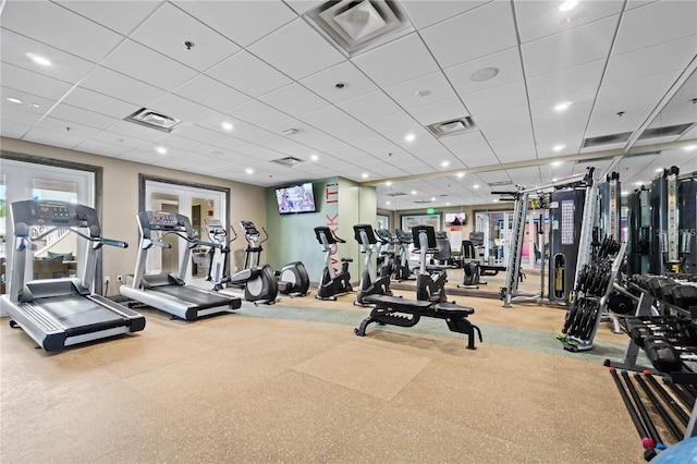 exercise room featuring french doors, visible vents, and a drop ceiling