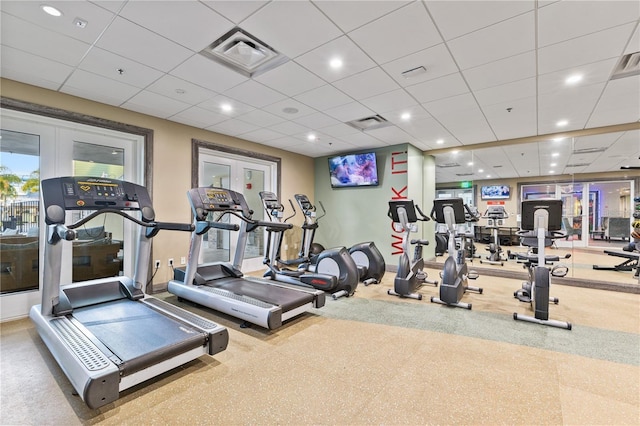 exercise room featuring french doors, visible vents, and a drop ceiling