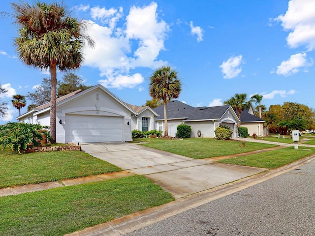 single story home featuring an attached garage, driveway, a front lawn, and stucco siding