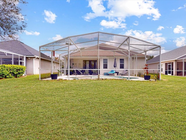 1718 Golfview Dr, Kissimmee, FL 34746 - rear view of house featuring glass enclosure, a patio area, and a lawn