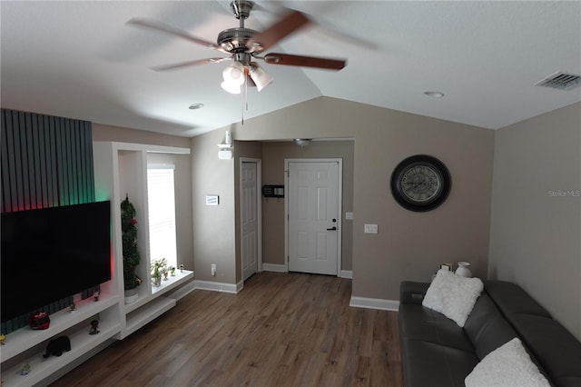 unfurnished living room with visible vents, a ceiling fan, wood finished floors, baseboards, and lofted ceiling