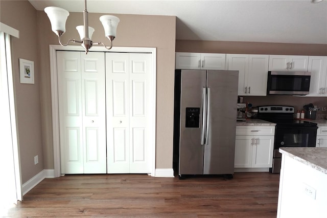 kitchen featuring white cabinetry, light wood-style flooring, a notable chandelier, and appliances with stainless steel finishes