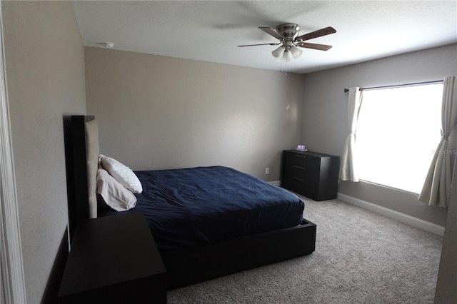 carpeted bedroom with baseboards and a ceiling fan