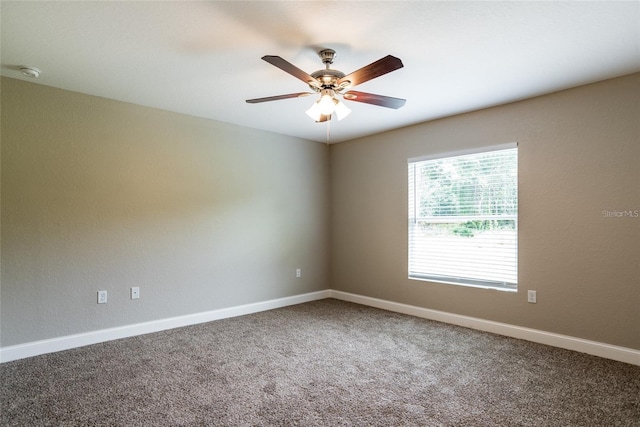 unfurnished room featuring carpet flooring, a ceiling fan, and baseboards