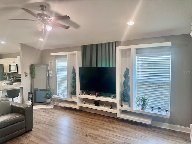 living area featuring recessed lighting, baseboards, a ceiling fan, and wood finished floors