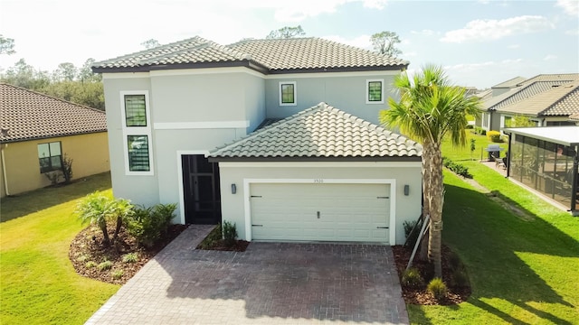 mediterranean / spanish-style home with a garage, a tiled roof, decorative driveway, and a front yard