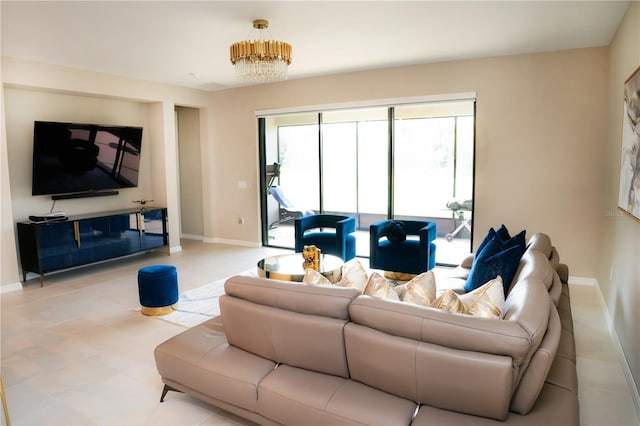 living area with a chandelier and baseboards