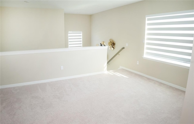 unfurnished room featuring carpet floors and baseboards