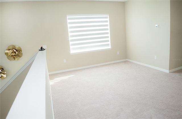 carpeted spare room with baseboards