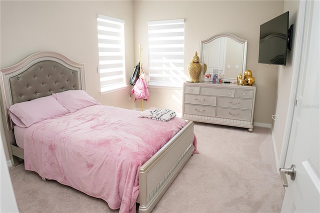 carpeted bedroom featuring baseboards