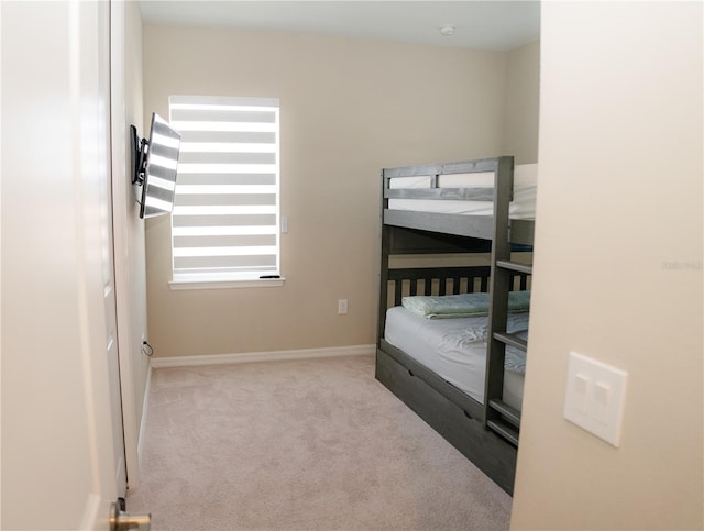 bedroom featuring carpet and baseboards