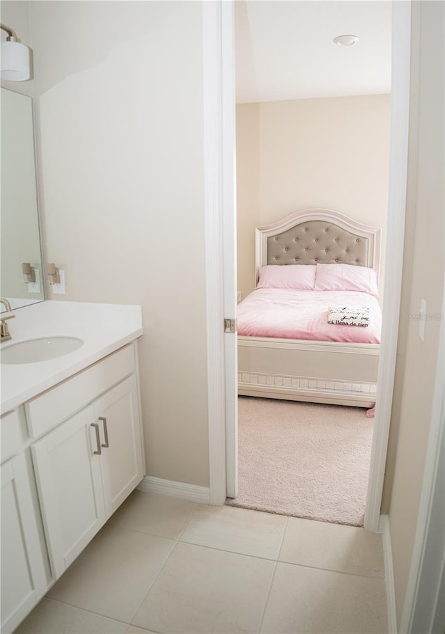 bathroom with tile patterned floors, baseboards, and vanity