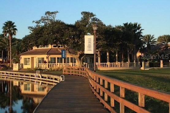 dock area with a water view and a yard