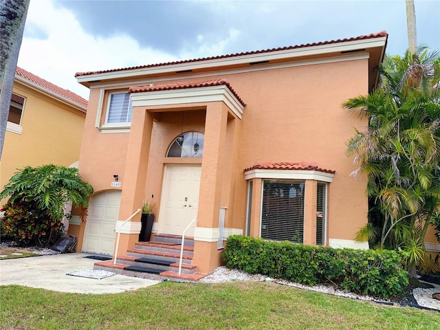 view of front of property with a garage, concrete driveway, a tile roof, and stucco siding