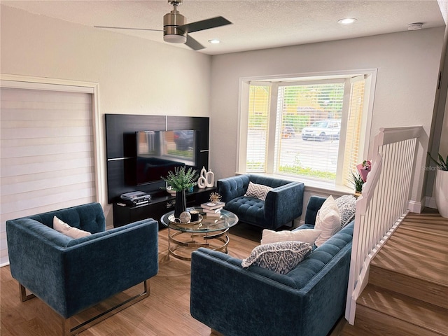 living room featuring a textured ceiling, ceiling fan, wood finished floors, and recessed lighting