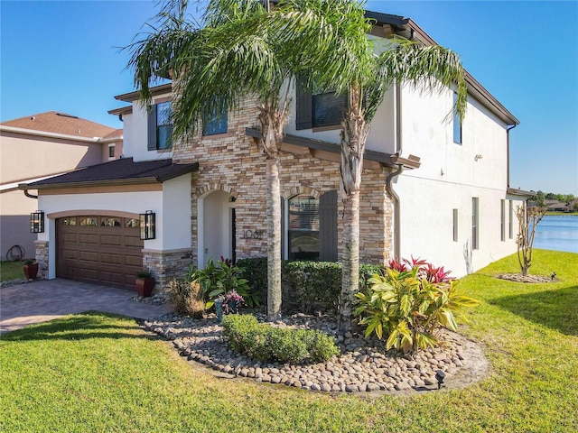 view of front of home with a garage, stone siding, decorative driveway, a front lawn, and stucco siding