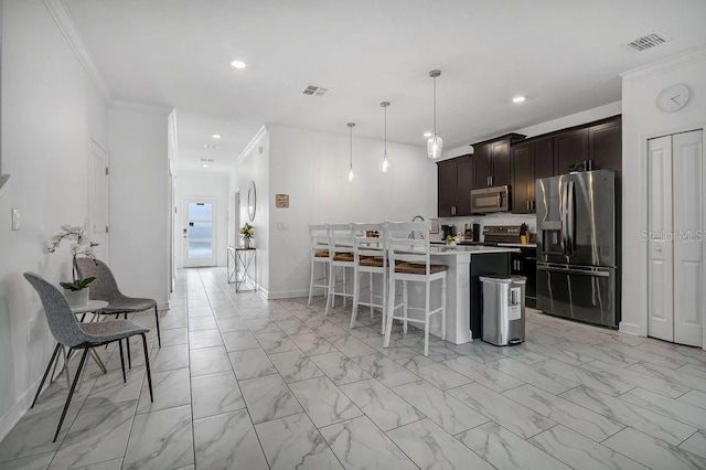 kitchen with visible vents, crown molding, dark brown cabinetry, a breakfast bar, and stainless steel appliances