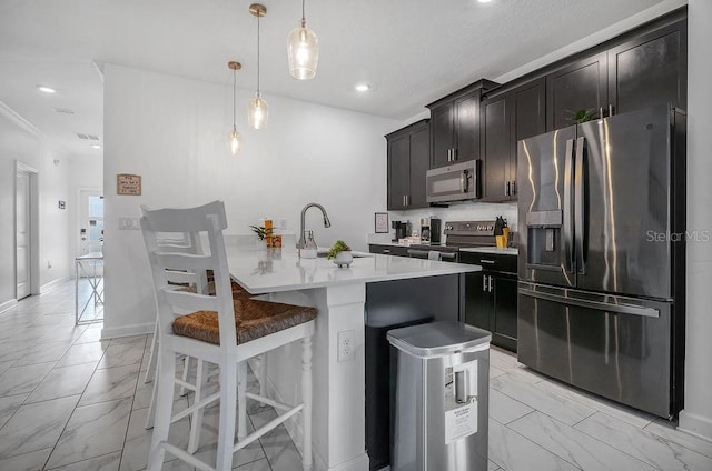 kitchen with a breakfast bar area, a sink, light countertops, appliances with stainless steel finishes, and marble finish floor