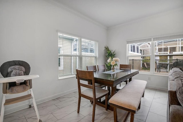 dining area with a wealth of natural light, baseboards, marble finish floor, and crown molding