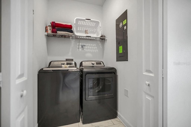 washroom featuring electric panel, baseboards, and washing machine and dryer