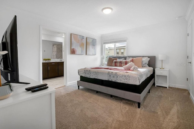 bedroom with light colored carpet, ensuite bath, baseboards, and ornamental molding