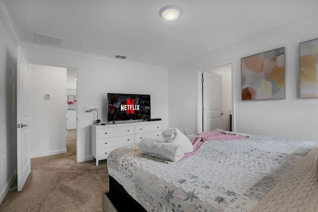 carpeted bedroom featuring visible vents, baseboards, and ornamental molding