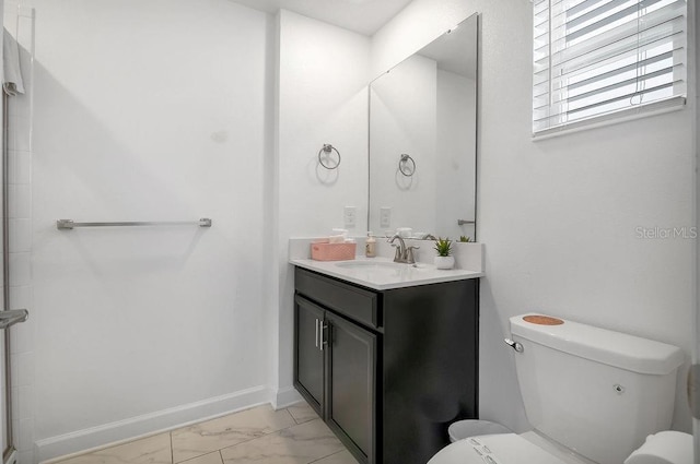 bathroom with baseboards, toilet, marble finish floor, and vanity