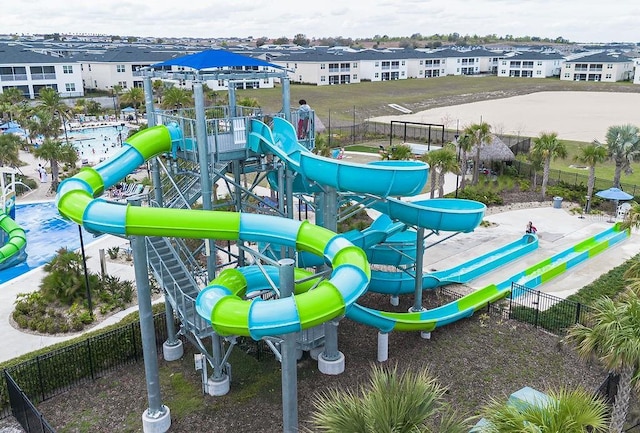 community play area with a residential view and fence