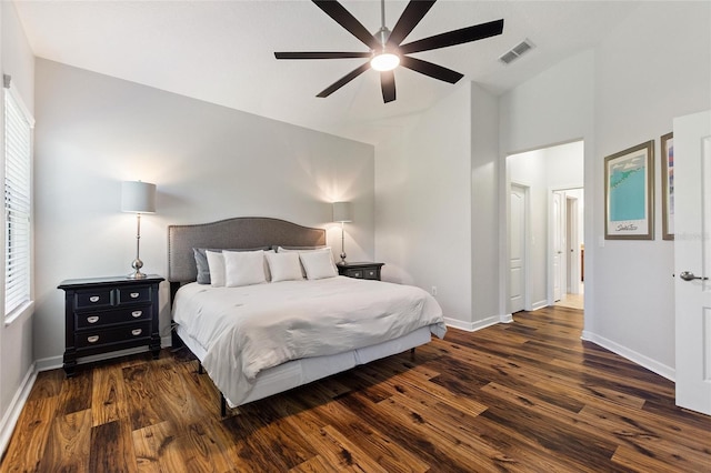 bedroom with dark wood-type flooring, visible vents, ceiling fan, and baseboards