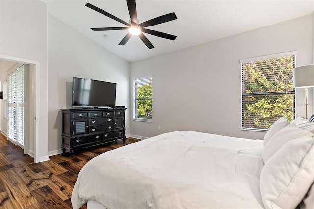 bedroom with lofted ceiling, dark wood-style floors, baseboards, and a ceiling fan