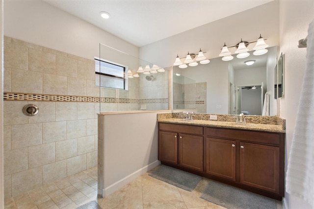 full bathroom featuring a sink, double vanity, walk in shower, and tile patterned floors