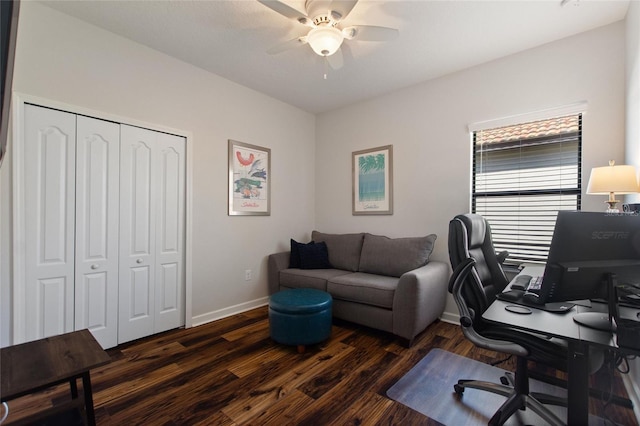 office space with dark wood-type flooring, a ceiling fan, and baseboards