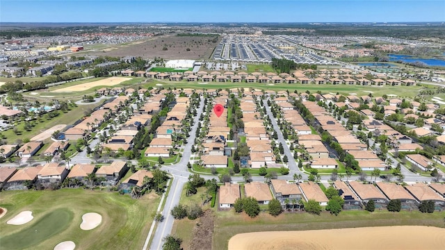 drone / aerial view with a water view, a residential view, and golf course view