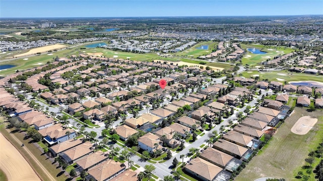 drone / aerial view with a water view, a residential view, and golf course view