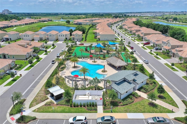 drone / aerial view featuring a residential view and a water view